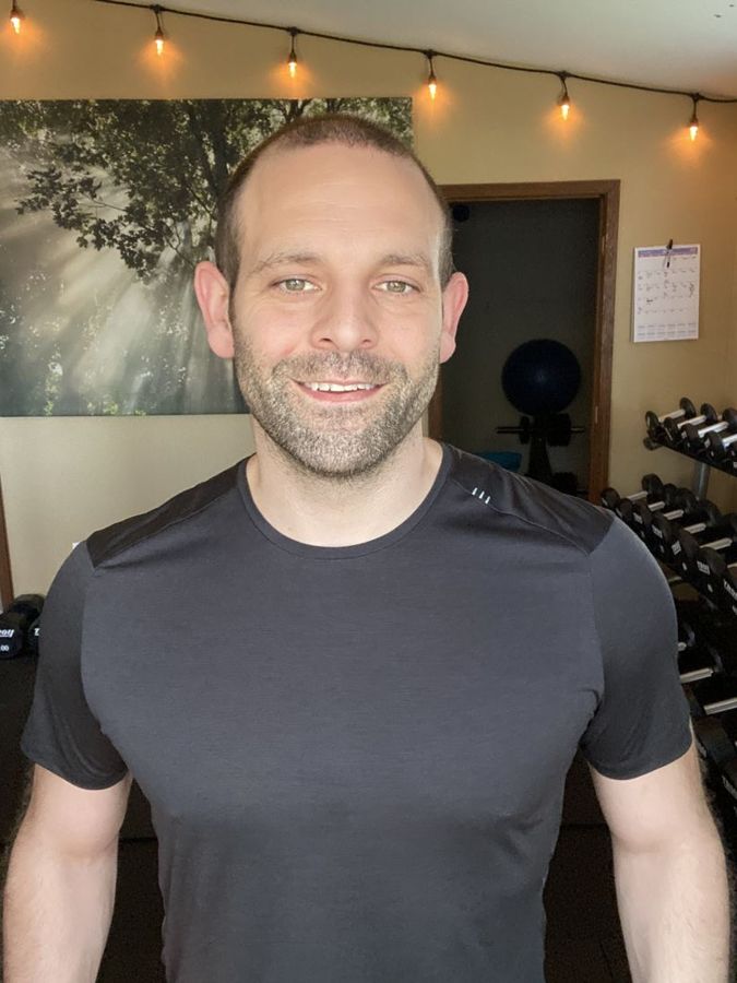 Andy Aversano smiling in his private gym